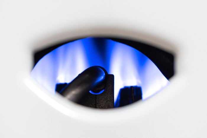 01_Close-up_view_of_a_boiler_burner_with_blue_f